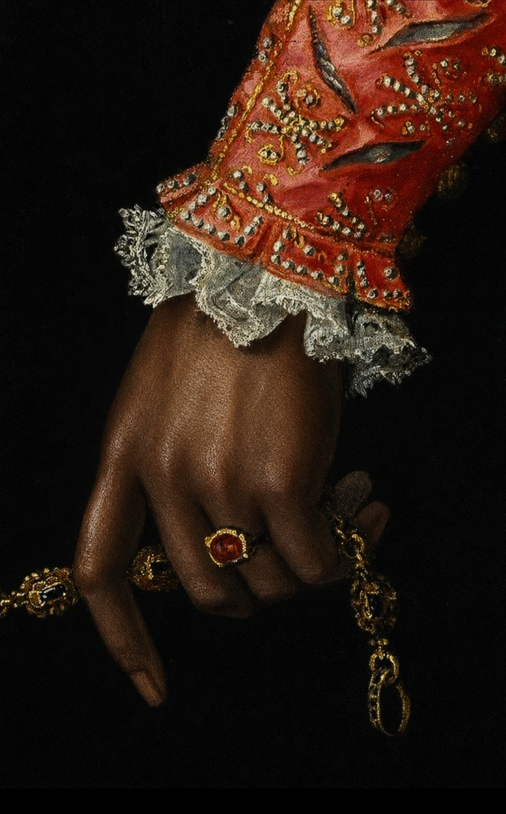 Classical painting detail of a hand with rings and an ornate red embroidered sleeve
